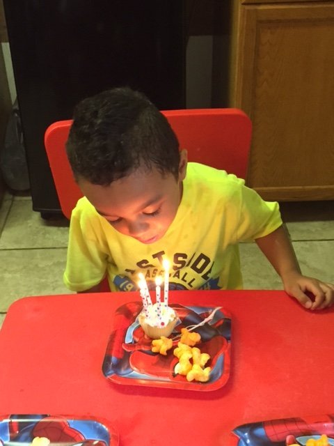 Kid blowing a candle